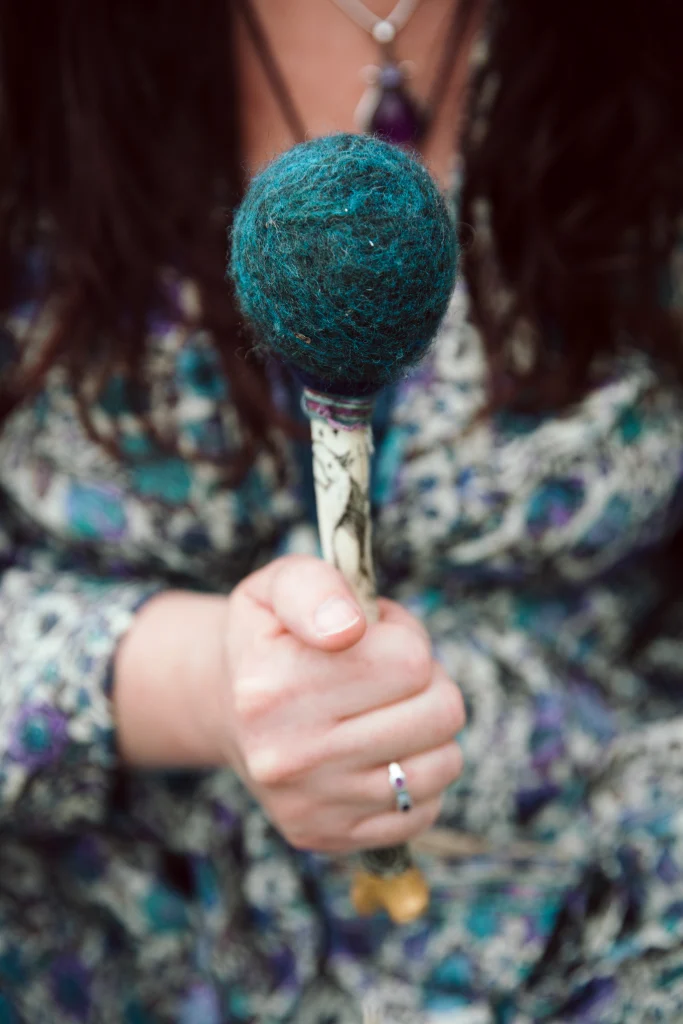 Sophie Messager holding out a drumstick to the camera