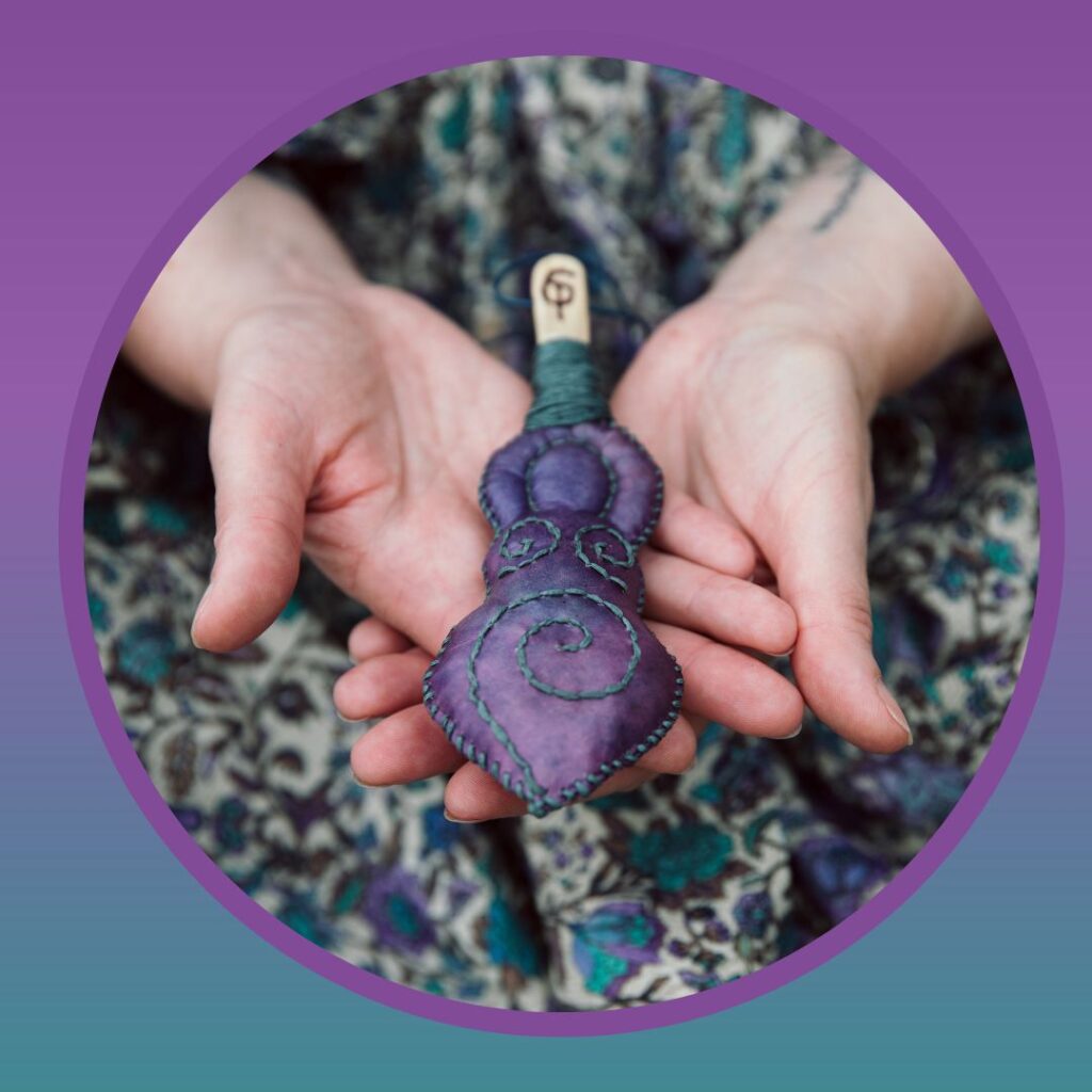 Sophie close up hands holding goddess rattle