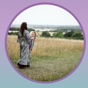 sophie from the back walking on meadows with drum